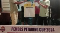 Kepala Desa Pekan Tanjung Beringin menyerahkan kostum kepada perwakilan Peserta Tournament
