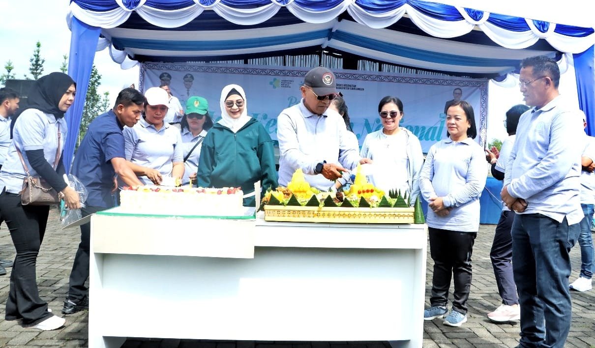 Bupati Simalungun, Dr H Anton Achmad Saragih, didampingi Ketua TP PKK Ny. Hj Darmawati Anton Achmad Saragih saat pemotongan nasi tumpeng. 
