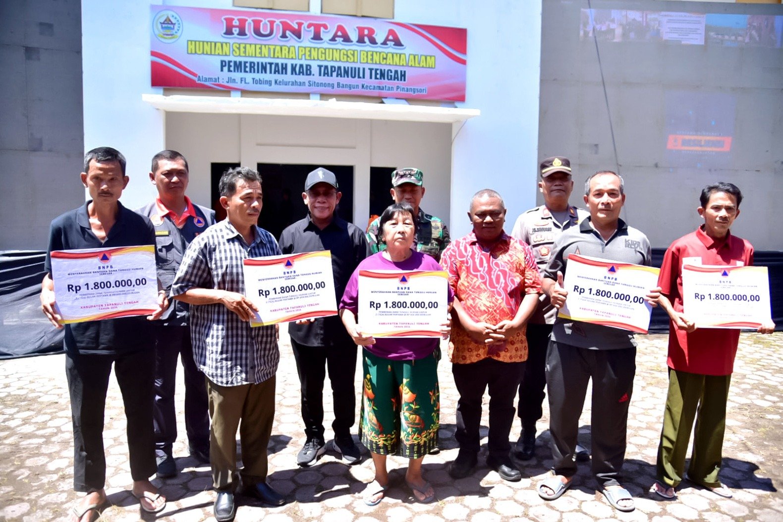 Bupati Tapteng Masinton Pasaribu saat menyerahkan Dana Tunggu Hunian (DTH) secara simbolis kepada warga yang terkena bencana, Kamis (5/2/2026).