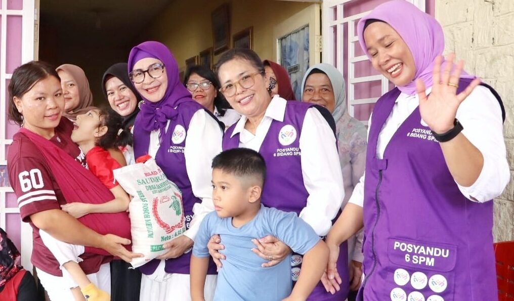 Ny. Hj. Darmawati Anton Achmad Saragih serahkan paket sembako.