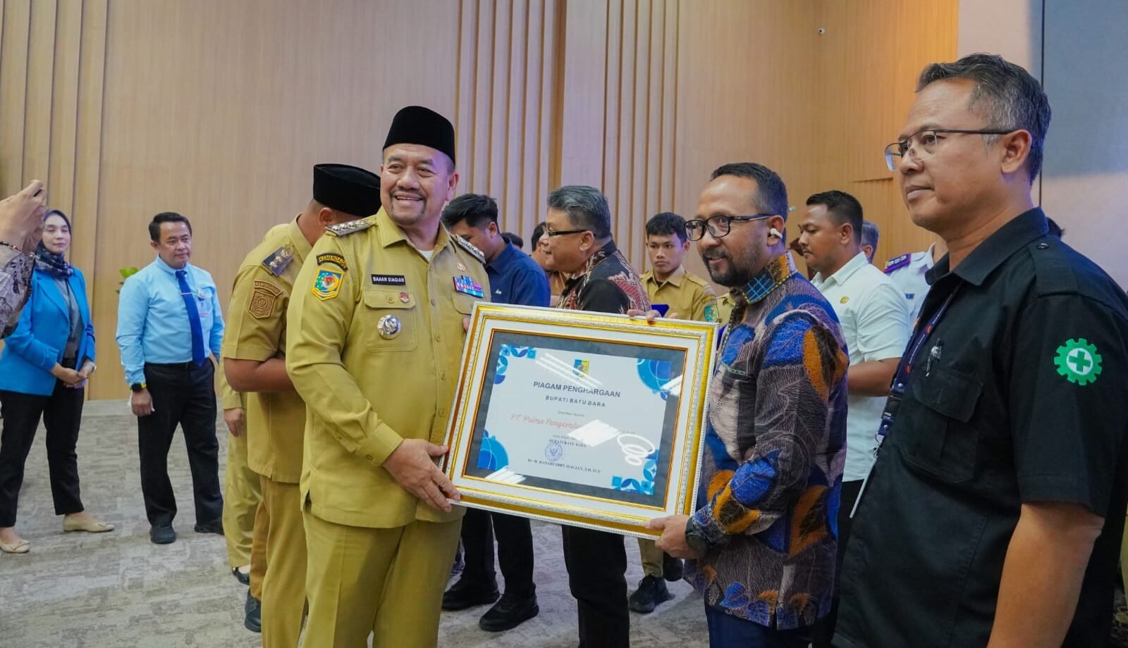 Baharuddin Siagian, Bupati Batu Bara sedang menyerahkan Piagam Penghargaan.