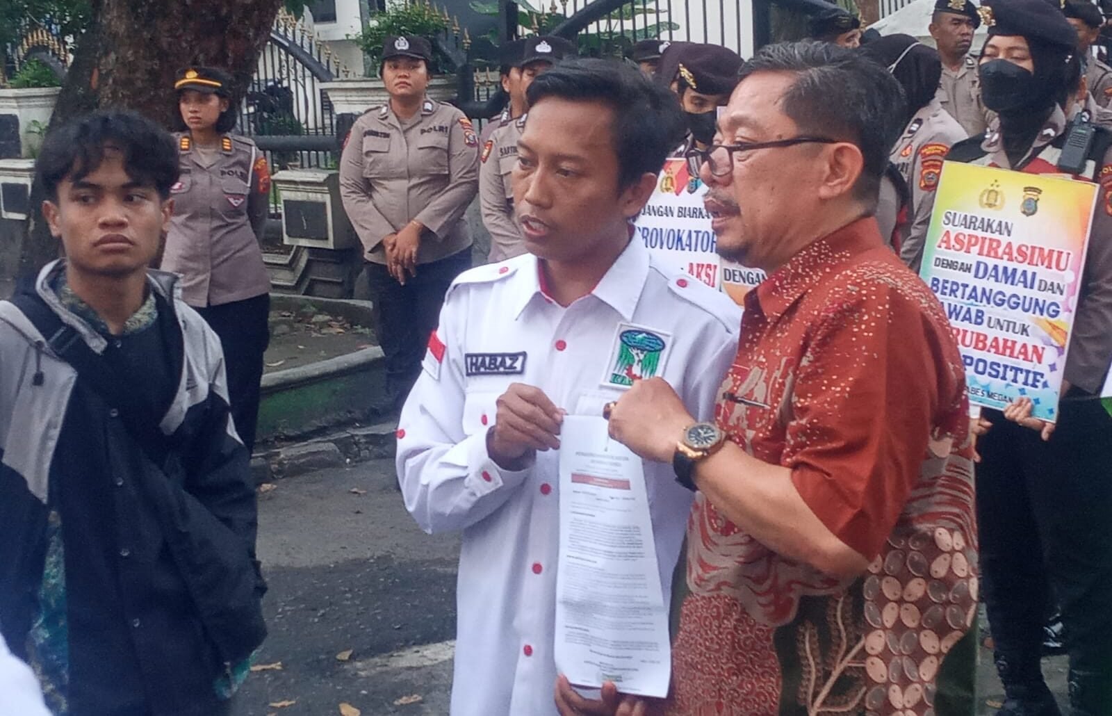 Kepala Humas Sekretariat DPRD Sumut M Sofyan Tanjung (kanan, baju batik) menerima pernyataan sikap PW KAMMI Sumut tatkala berunjuk rasa di DPRD Sumut. 